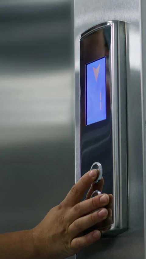 Nurse comes to elevator door and presses call button Stock Footage 274899331