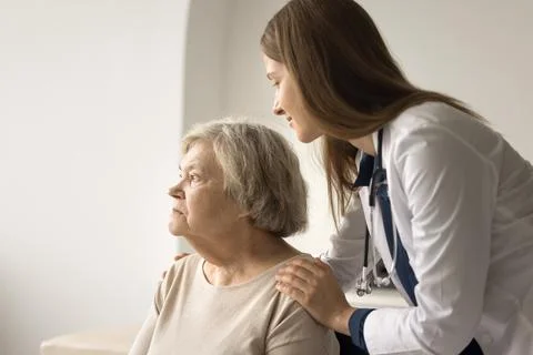 Nurse comforting upset pensioner after bad health test results news Stock Photos