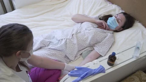 The nurse communicates with the bedridden patient Video stock 147029968