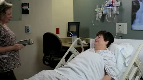 Nurse computer charting at bedside Stock Footage 12508263