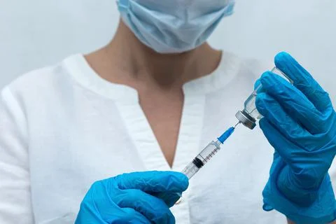 Nurse dials the injection into the syringe, vaccination Stock Photos