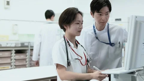 Nurse Discussing While Reviewing Electronic Medical Records Stock Footage 333166732