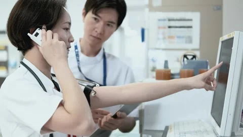 Nurse Discussing While Reviewing Electronic Medical Records Stock Footage 333166741