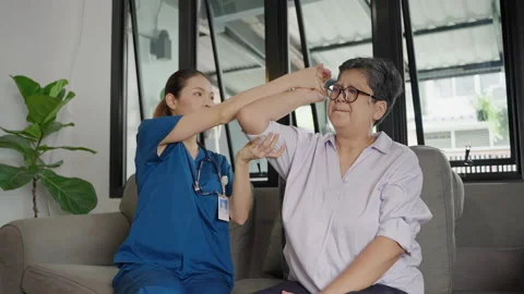 Nurse doing arm exercises for elderly people in nursing homes Stock Footage 162407788