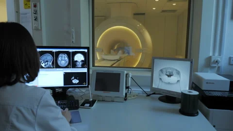 Nurse doing electro magnetic tomography to the patient Stock Footage 97207789