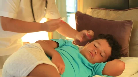 Nurse dripping eardrops to child in bed room 2 Stock Footage 66435309