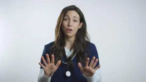 Nurse emphatically cautions and warns viewer against doing something Stock Photos