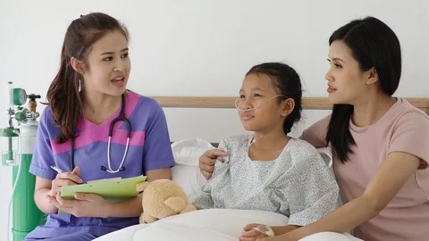 Nurse explaining about nursing care to patient family Stock Footage 89861416