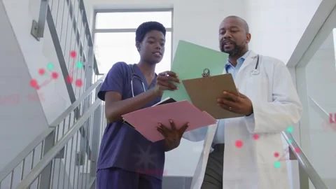 Nurse flipping green folder doc scanning notes on stairs aligning med records Stock Footage 333078379