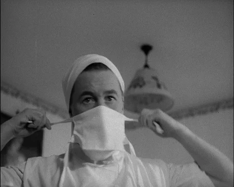 Nurse getting herself and her instruments ready to help woman in labour, 1952 스톡 동영상 133377584
