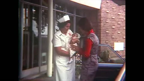 Nurse gives woman newborn baby 8mm 1960s Stock Footage