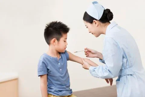 Nurse giving boy injection Stock Photos