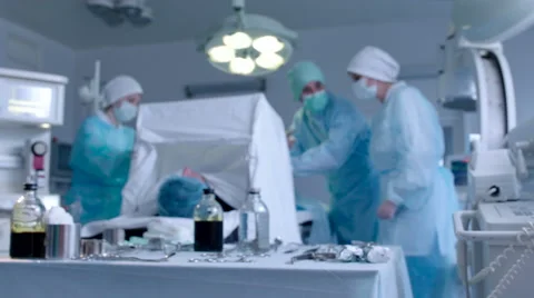Nurse Giving a Tissue Forceps to Surgeon Stock Footage 50063952