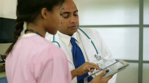 Nurse goes over results using a tablet pc Stock Footage