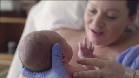 Nurse Hands Newborn Baby to Mother After Birth in Hospital Delivery Room Stock Footage