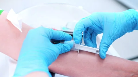 Nurse hands in protective gloves take blood from patient's vein for health test Stock Footage 298926188