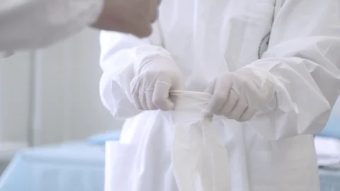 Nurse help surgeon to put the latex gloves on hands Stock Footage 101478539