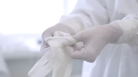 Nurse help surgeon to put the latex gloves on hands 2 Stock Footage 101478540