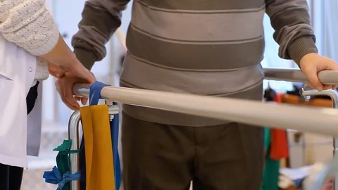 Nurse is helping to elderly man for physical therapy Stock Footage 127284004