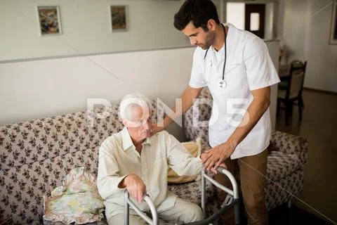 Nurse Helping Senior Man To Stand Up