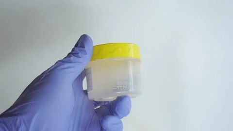 Nurse holding container with urine sample at table, closeup and space for text Stock Footage 322633407