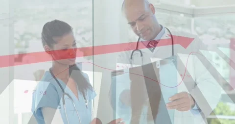 Nurse holding X-ray adding red trend overlay while doctor rotating and Stock Footage 327592909