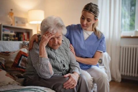 Nurse hugging elderly patient, mental health support and grief counseling to Stock Photos