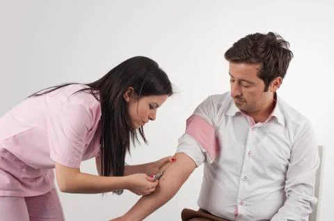 Nurse injecting to a man Stock Photos