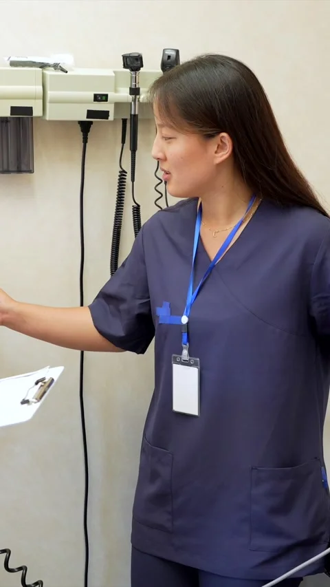 Nurse learning how to measure blood pressure with doctor supervision Stock Footage 310658882
