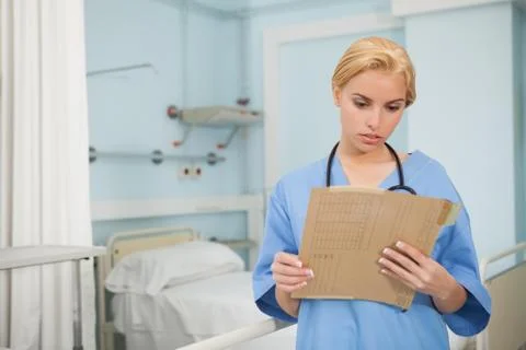 Nurse looking at a folder Stock Photos