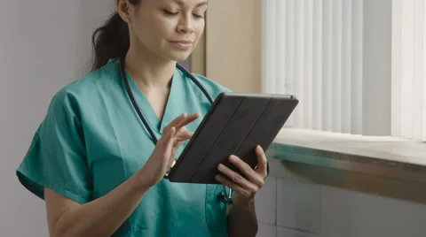 Nurse looking at her tablet Video stock 63013850
