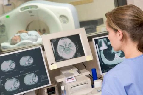 Nurse monitoring patient having a computerized axial tomography (cat) scan Stock Photos