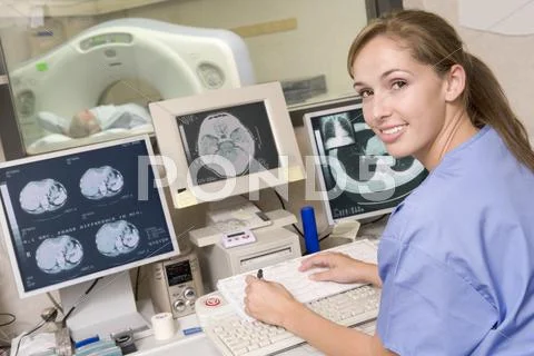 Nurse Monitoring Patient Having A Computerized Axial Tomography (Cat) Scan