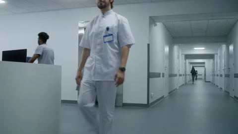 Nurse with old patient wait for elevator in medical center hallway Stock Footage 249790666