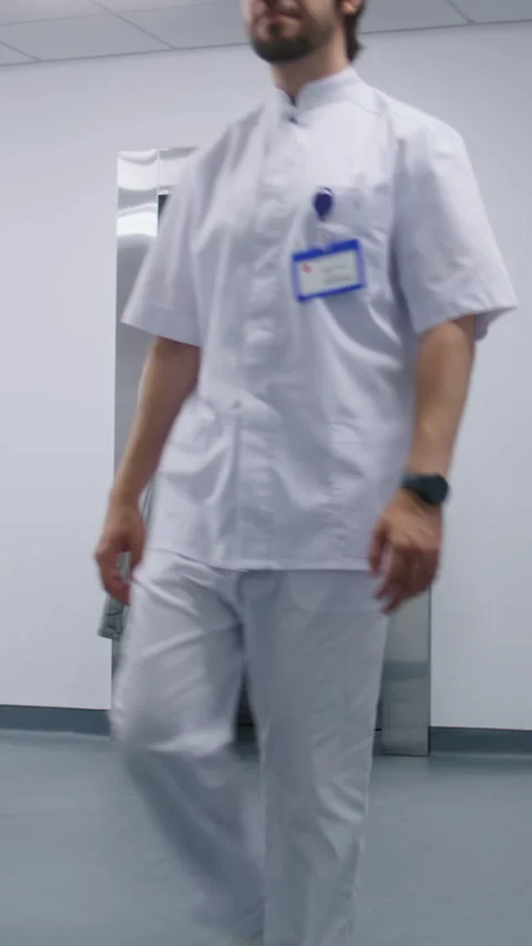 Nurse with old patient wait for elevator in medical center hallway Stock Footage 274900523