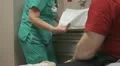 nurse with patient writing in chart HD Footage
