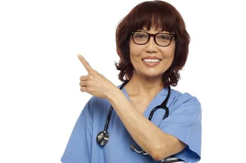 Nurse pointing at the copy space Stock Photos