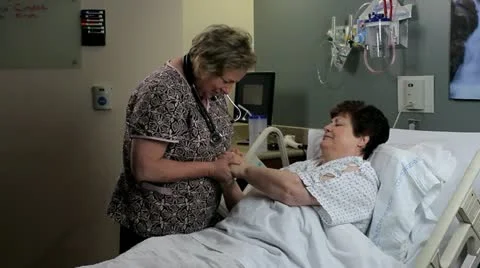 Nurse praying with patient Stock Footage