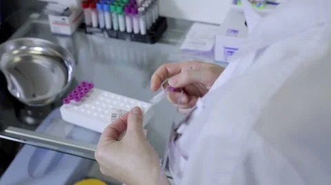 Nurse prepares and puts empty test tube in support Stock Footage 58031364