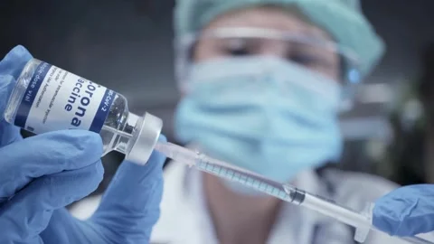Nurse prepares a syringe for an injection Medium closeup studio shot of a young 스톡 동영상 336587125