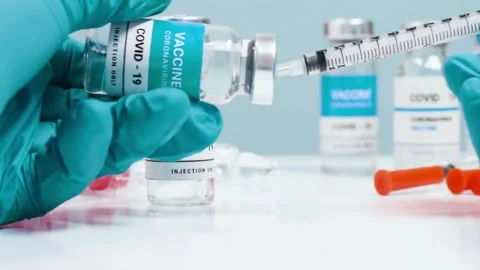 Nurse prepares a syringe for an injection Medium closeup studio shot of a young Stock-Footage 336587216