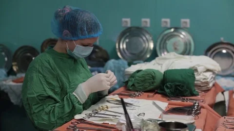 The nurse prepares the tools required for the operation Stock Footage 70811658