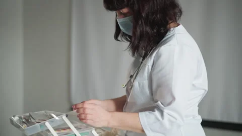 Nurse preparing medication box for discharge, masked clinician in white coat Stock Footage 346557283