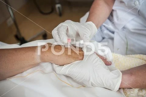 Nurse Preparing A Patient For An Iv Line