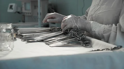 Nurse preparing sterile surgical instruments, healthcare worker prepares tools 스톡 동영상 201524720