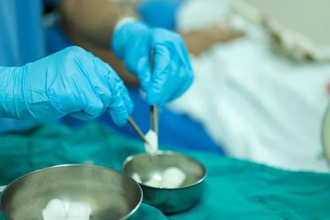 A nurse is preparing a tool to dressing the patient's wound. Stock Photos