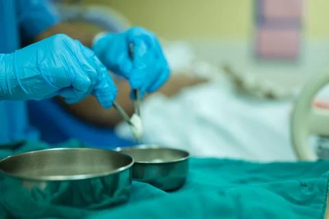 A nurse is preparing a tool to dressing the patient's wound. Stock Photos