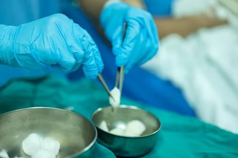 A nurse is preparing a tool to dressing the patient's wound. Stock Photos