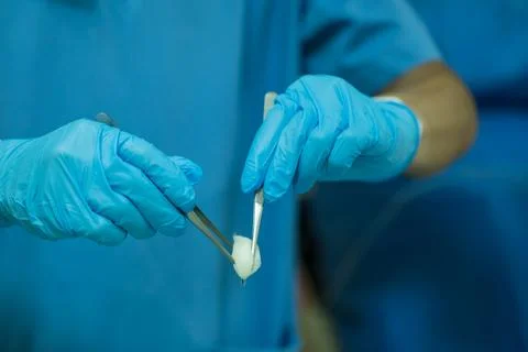 A nurse is preparing a tool to dressing the patient's wound. Stock Photos