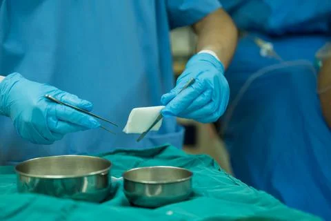 A nurse is preparing a tool to dressing the patient's wound. Stock Photos